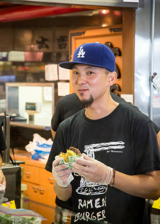 Chef Keizo eating the first ramen burger