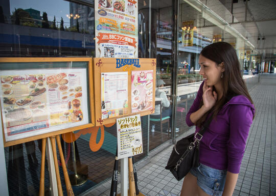 Allison looking at the Baseball Cafe menu