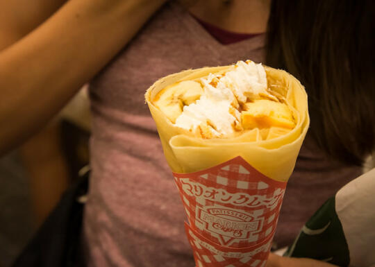 Crepe with banana, cheesecake, chocolate sauce, and whipped cream