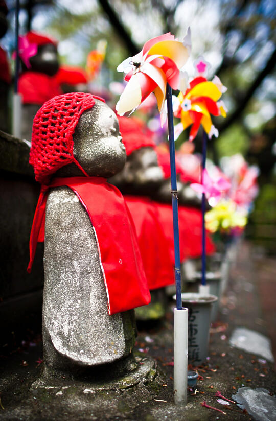 Dressed up children's statues with pinwheel