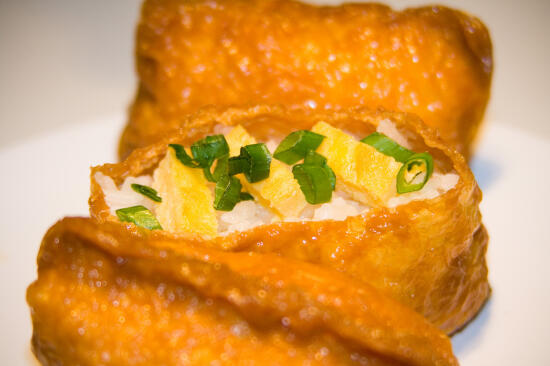 Inari-zushi, topped with tamago and green onion