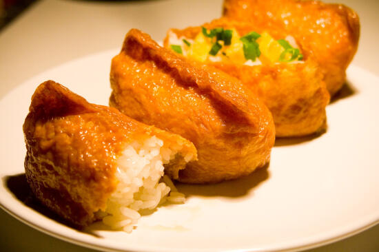 Inari-zushi, topped with tamago and green onion