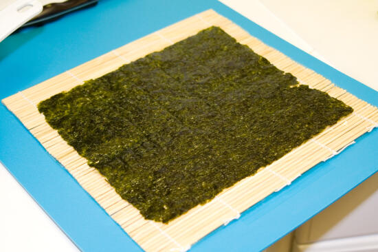 A piece of nori on the rolling mat