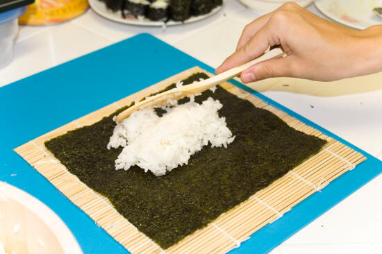 Placing rice on the nori