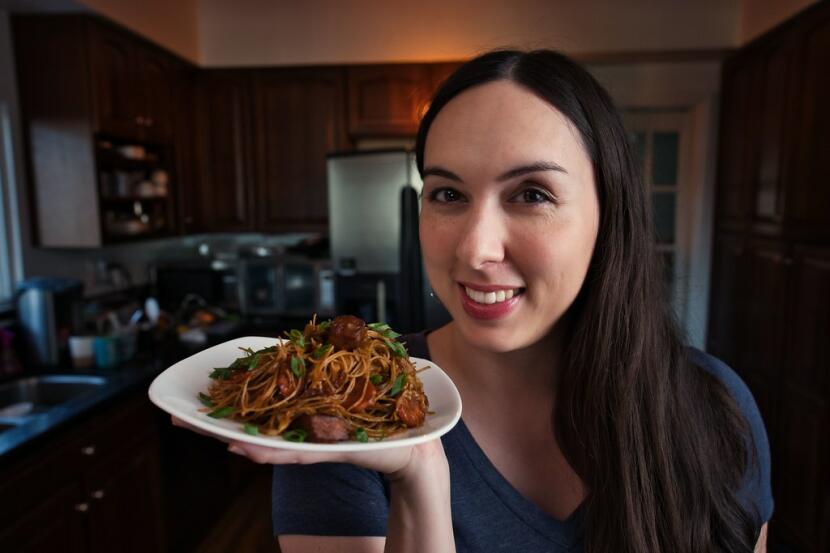 Allison holding a plate of pancit